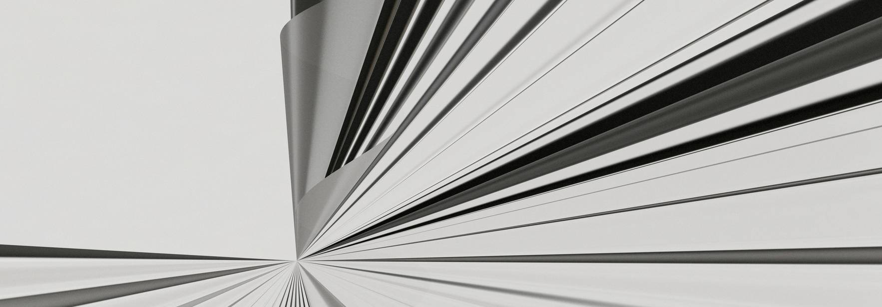 Una abstracción en blanco y negro que presenta líneas convergentes creando una sensación de profundidad.