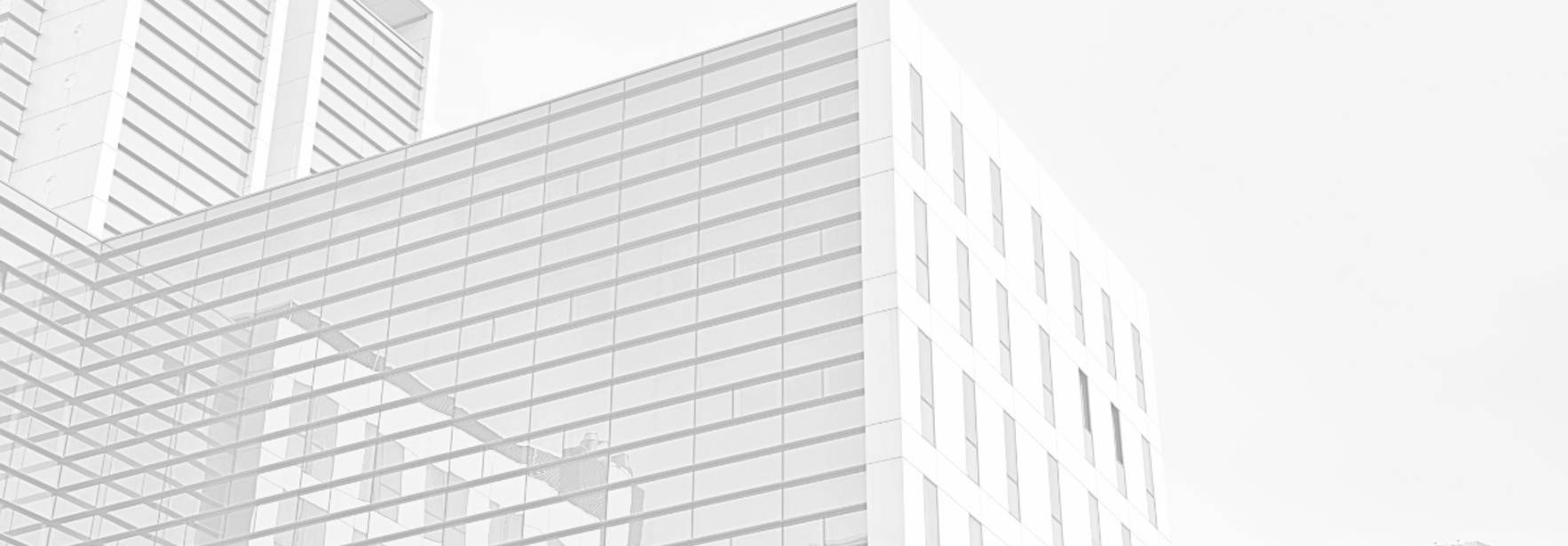 Una imagen de arquitectura moderna con edificios de cristal y líneas limpias.