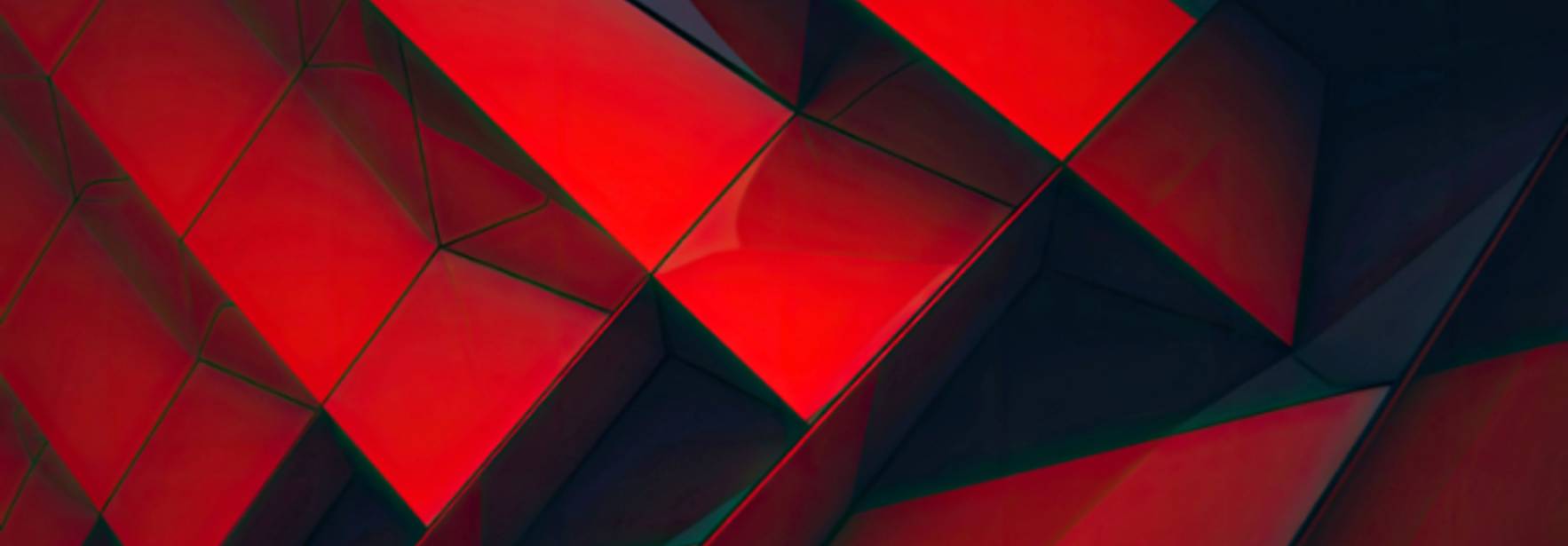 La imagen muestra una superficie con formas geométricas en tonos rojos, creando un efecto visual dinámico.