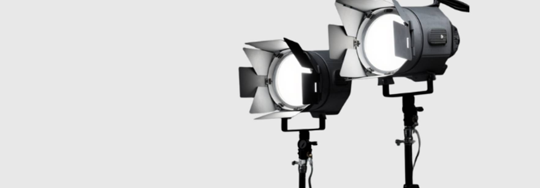 La imagen muestra dos luces de estudio profesionales sobre trípodes.