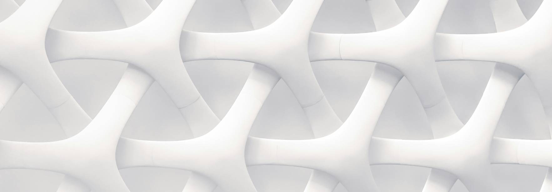 La imagen muestra una textura blanca con un patrón entrelazado de formas fluidas.