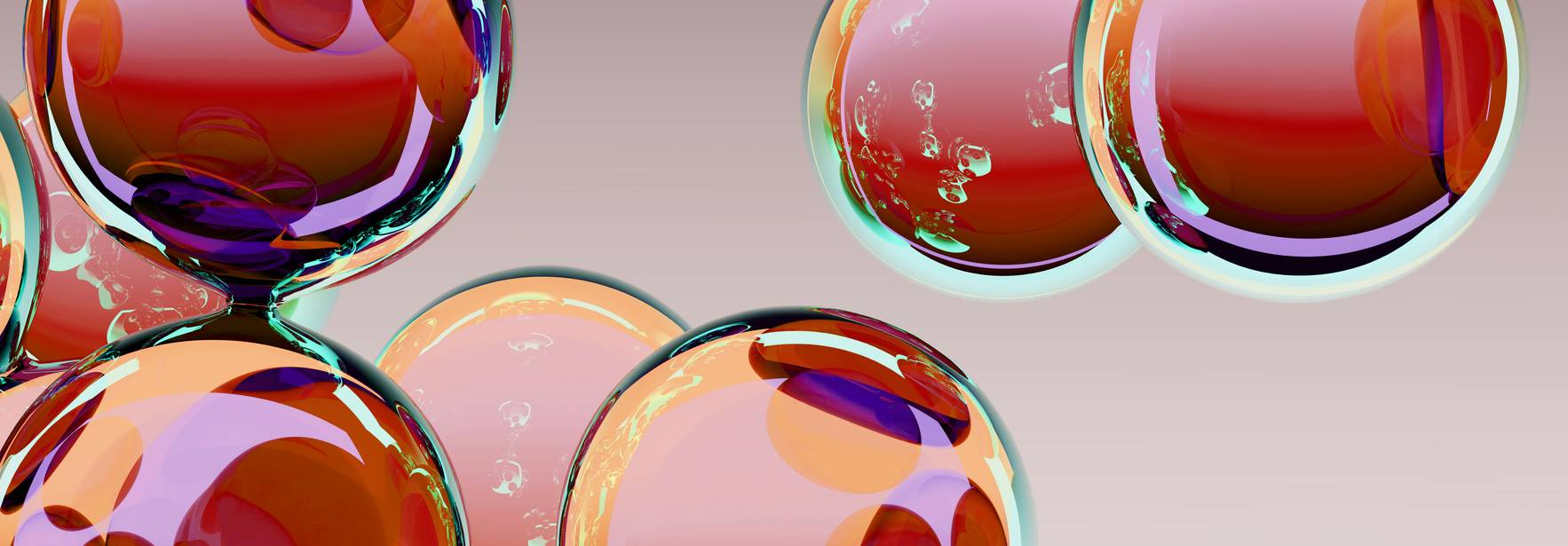 La imagen muestra una colección de burbujas de colores brillantes flotando sobre un fondo suave.