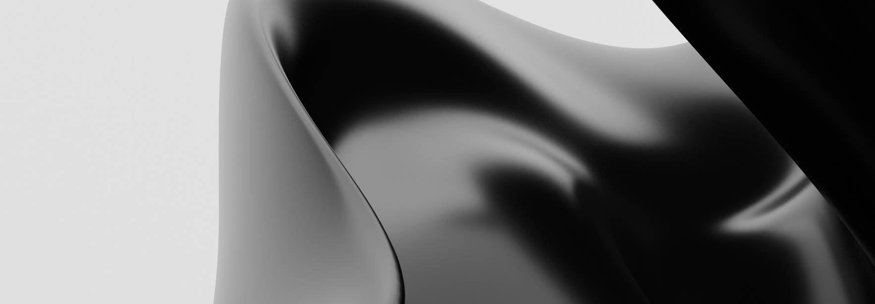La imagen presenta una escultura abstracta de color negro con formas onduladas y suaves.