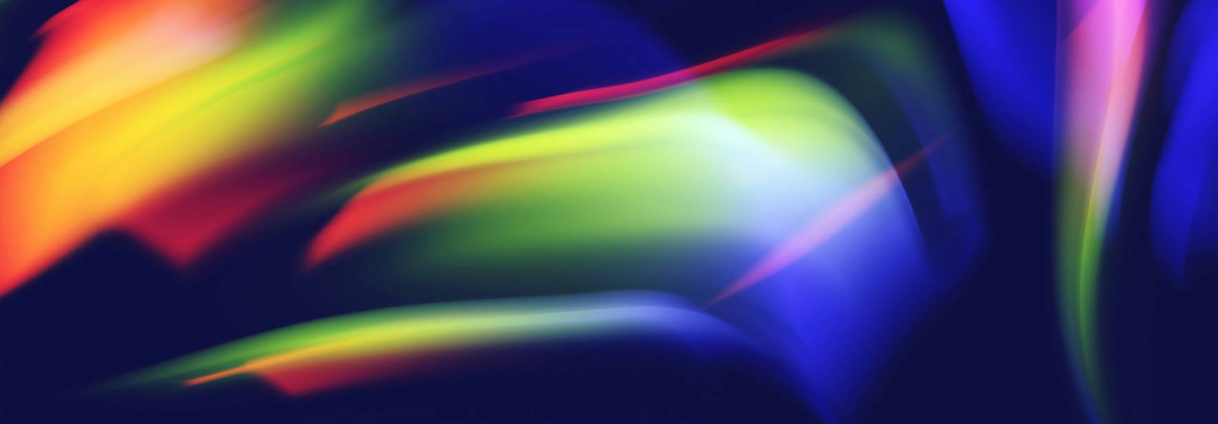 Una imagen abstracta con colores vibrantes que se mezclan en un fondo oscuro.