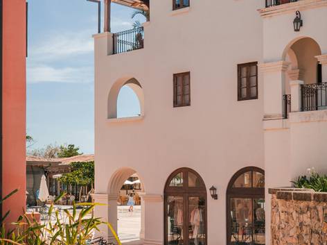 Una vista de un edificio con un diseño arquitectónico contemporáneo y arcos en su fachada.