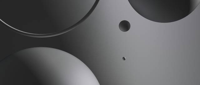 La imagen muestra una composición abstracta de formas esféricas en tonos oscuros.