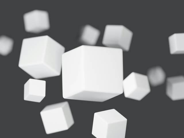 La imagen muestra varios cubos blancos flotando en un fondo gris.