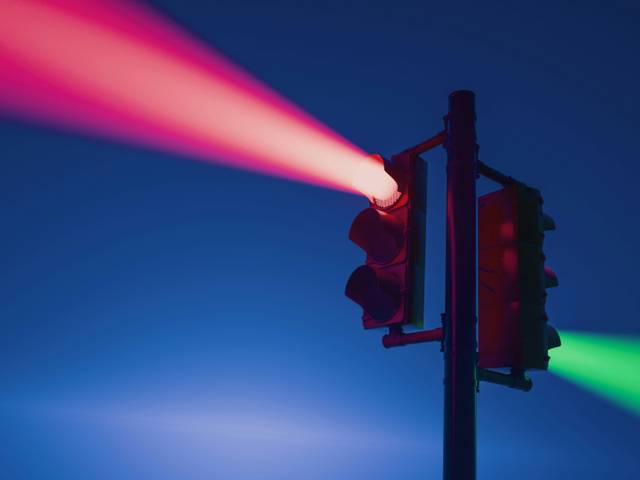 Un semáforo emitiendo luces roja y verde en una noche oscura.