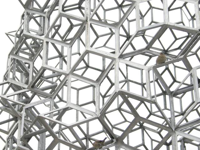 Estructura geométrica hecha de cubos interconectados en color metálico.