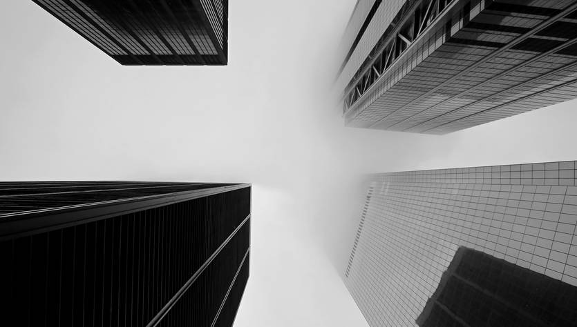 Una vista en ángulo de edificios altos bajo un cielo nublado.
