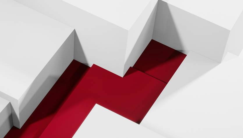 La imagen muestra un camino rojo que se abre paso entre estructuras blancas en un entorno minimalista.