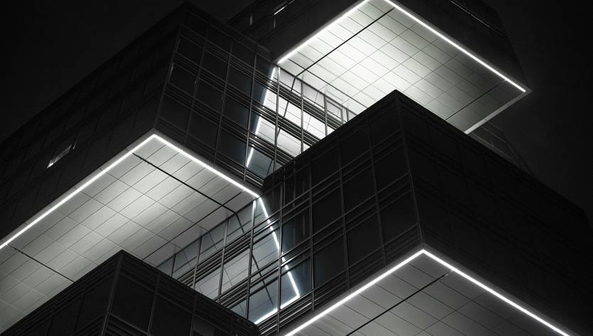 Una moderna estructura arquitectónica iluminada con un diseño geométrico y líneas rectas.